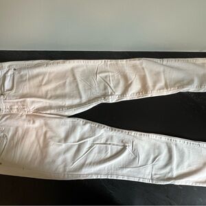 White jeans with beaded detail. Zippers at bottom cuffs. Size 6.